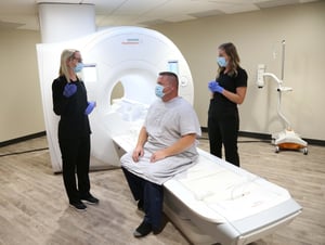 MAN-sitting-on-MRI-table