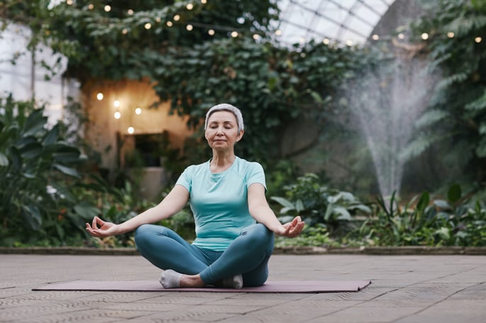 woman-meditating-in-garden