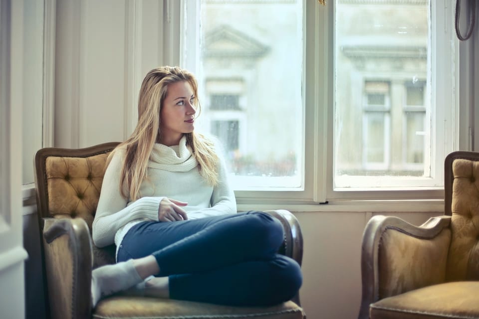 woman sitting in a brown chair