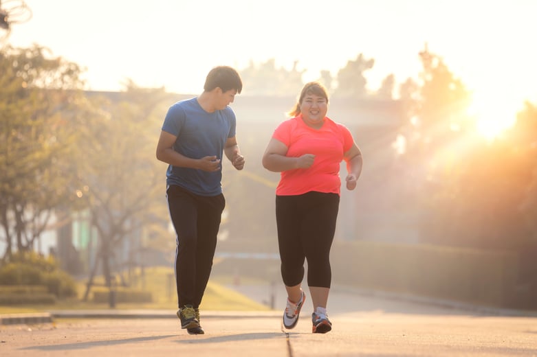 woman-in-bright-pink-shirt-running-with-her-trainer