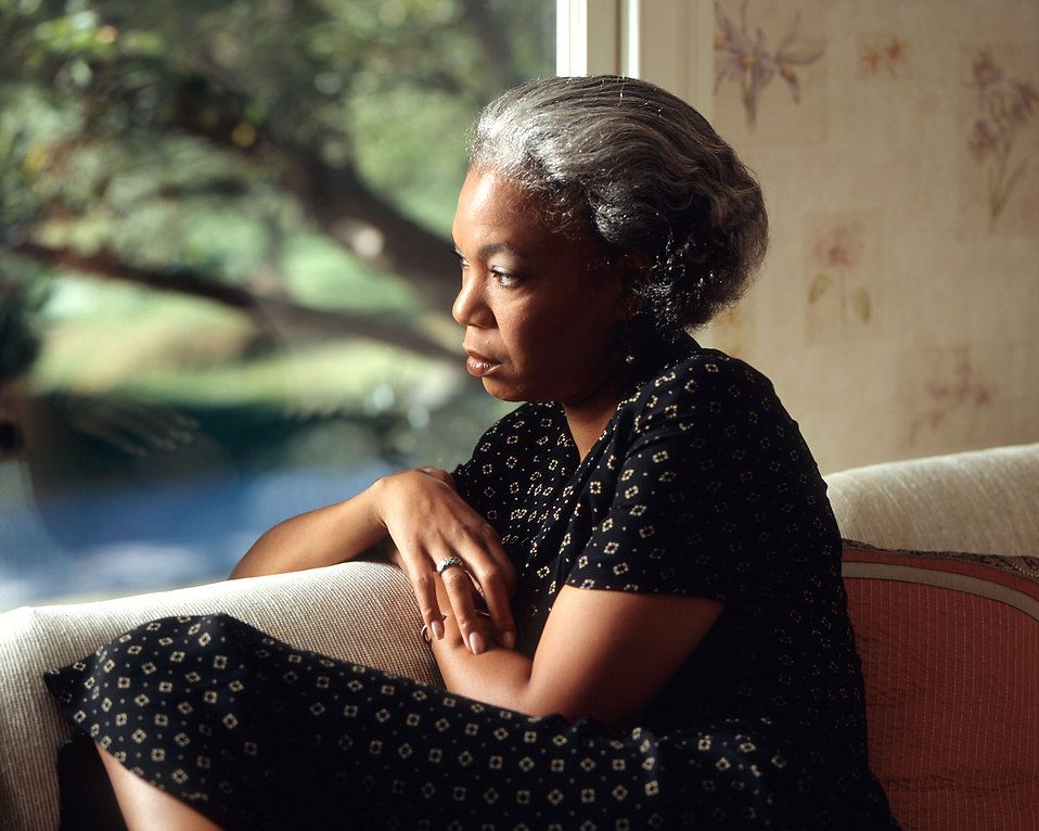 worried woman looking out window